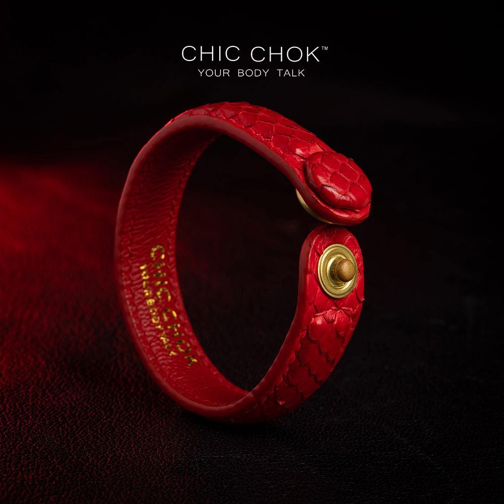 chicchok red scaled leather bracelet featuring a bold circular clasp and luxurious gold branding, designed to inspire confidence and elevate any outfit