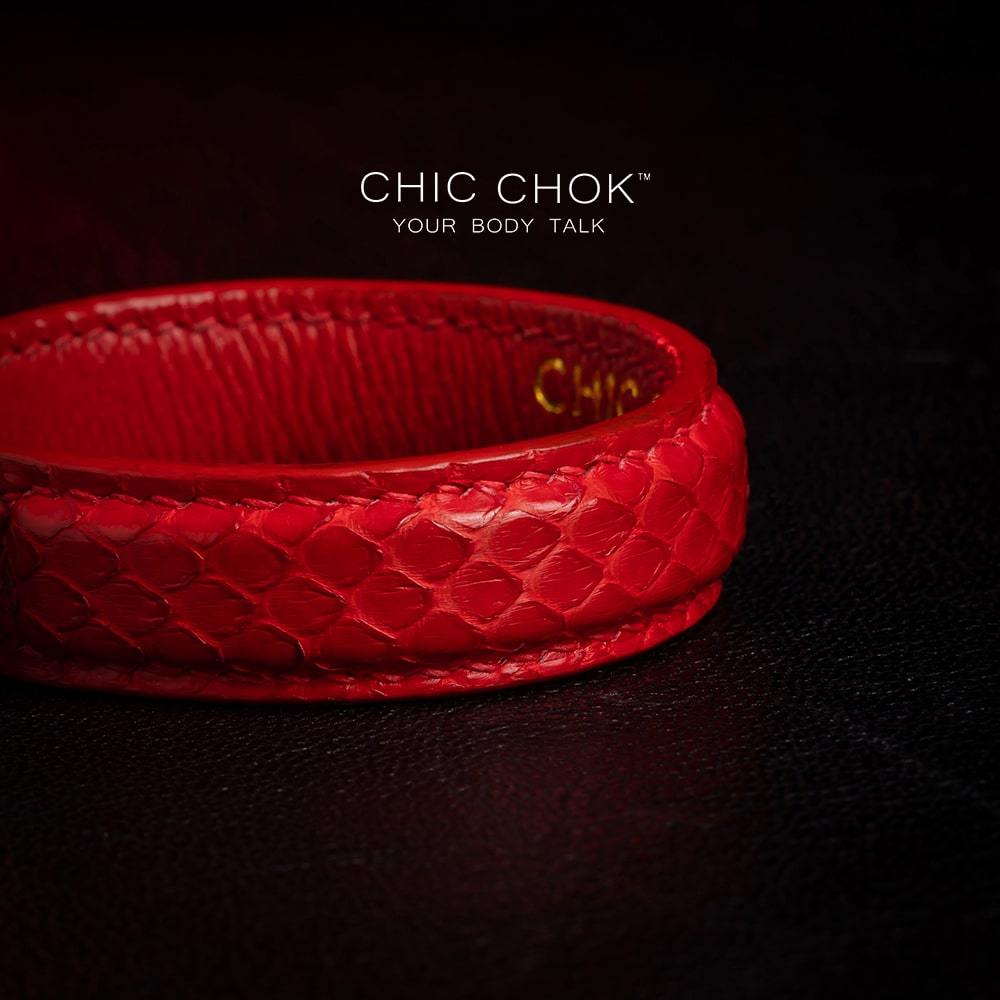 chicchok red scaled leather bracelet featuring a bold circular clasp and luxurious gold branding, designed to inspire confidence and elevate any outfit