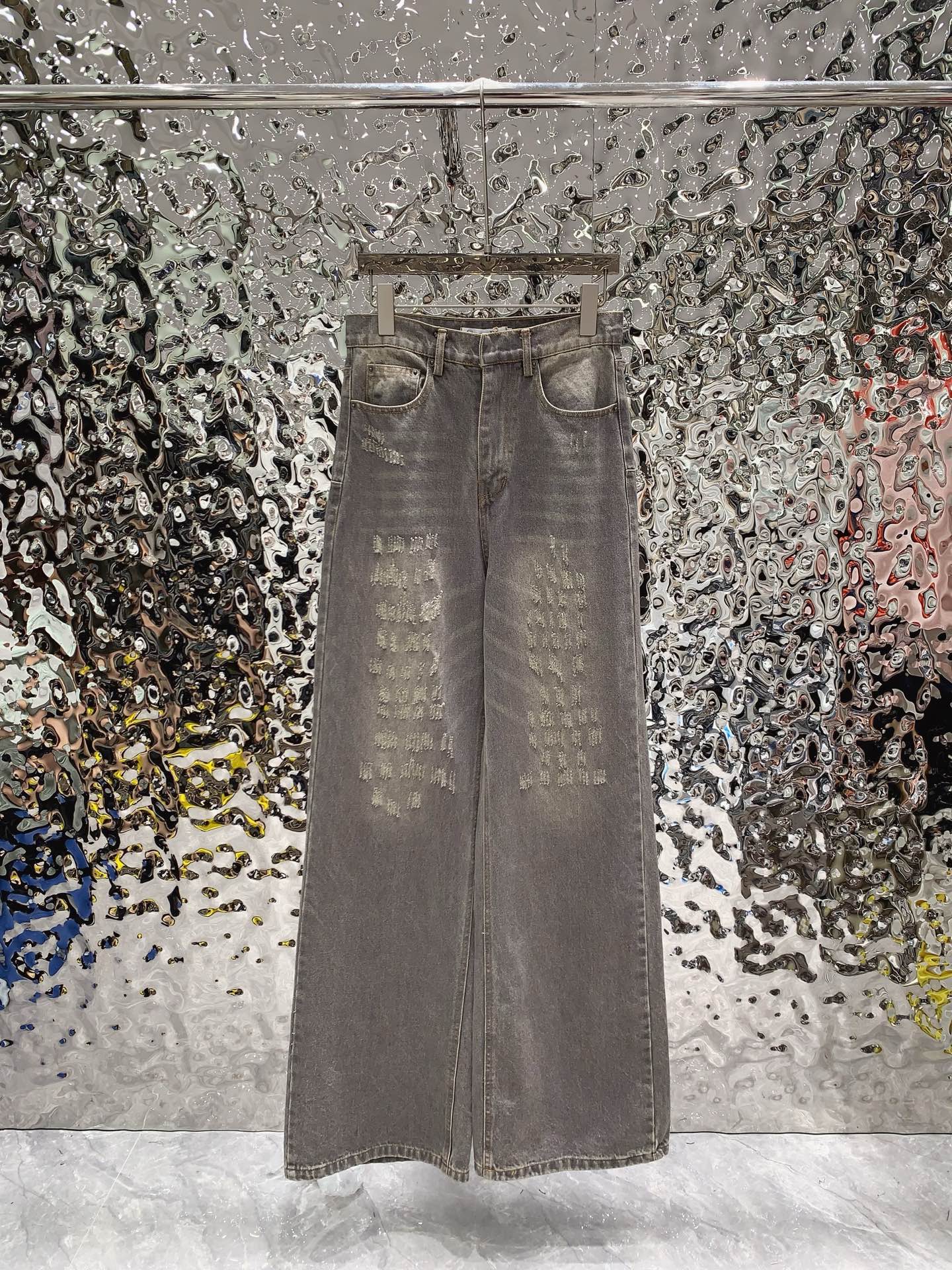 Stonewashed grey damaged cotton flared jeans