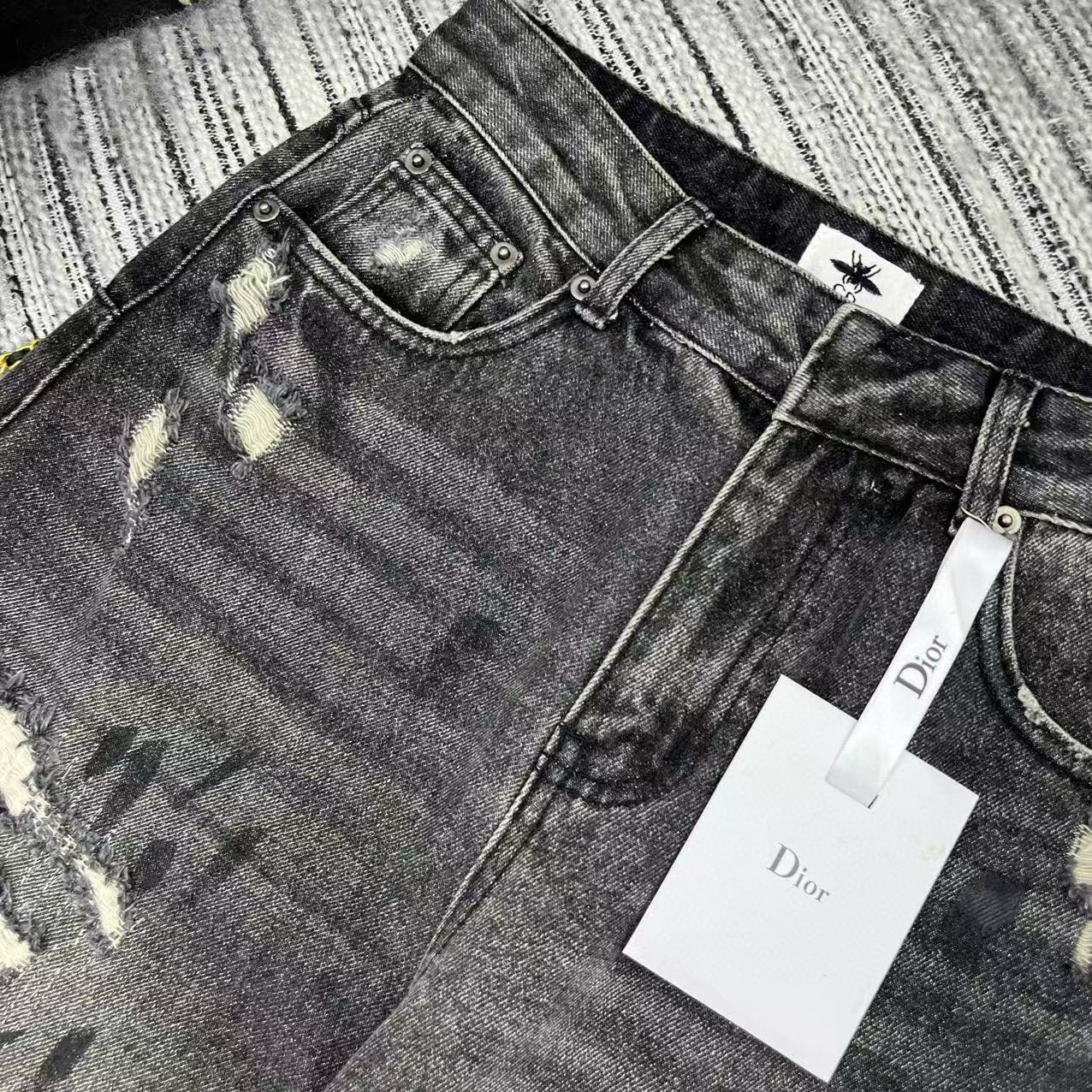 Stonewashed grey damaged cotton flared jeans