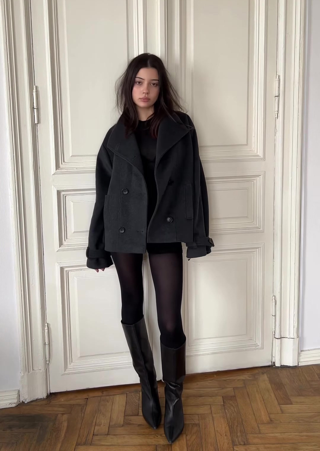 Black double-breasted wool peacoat worn
