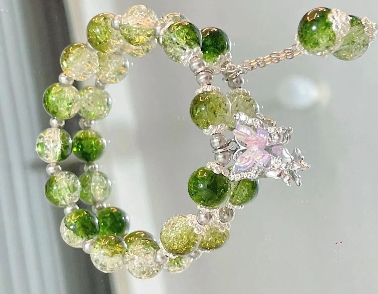 Pink, green, and blue butterfly glaze bracelets with silver charms, perfect for gifting.