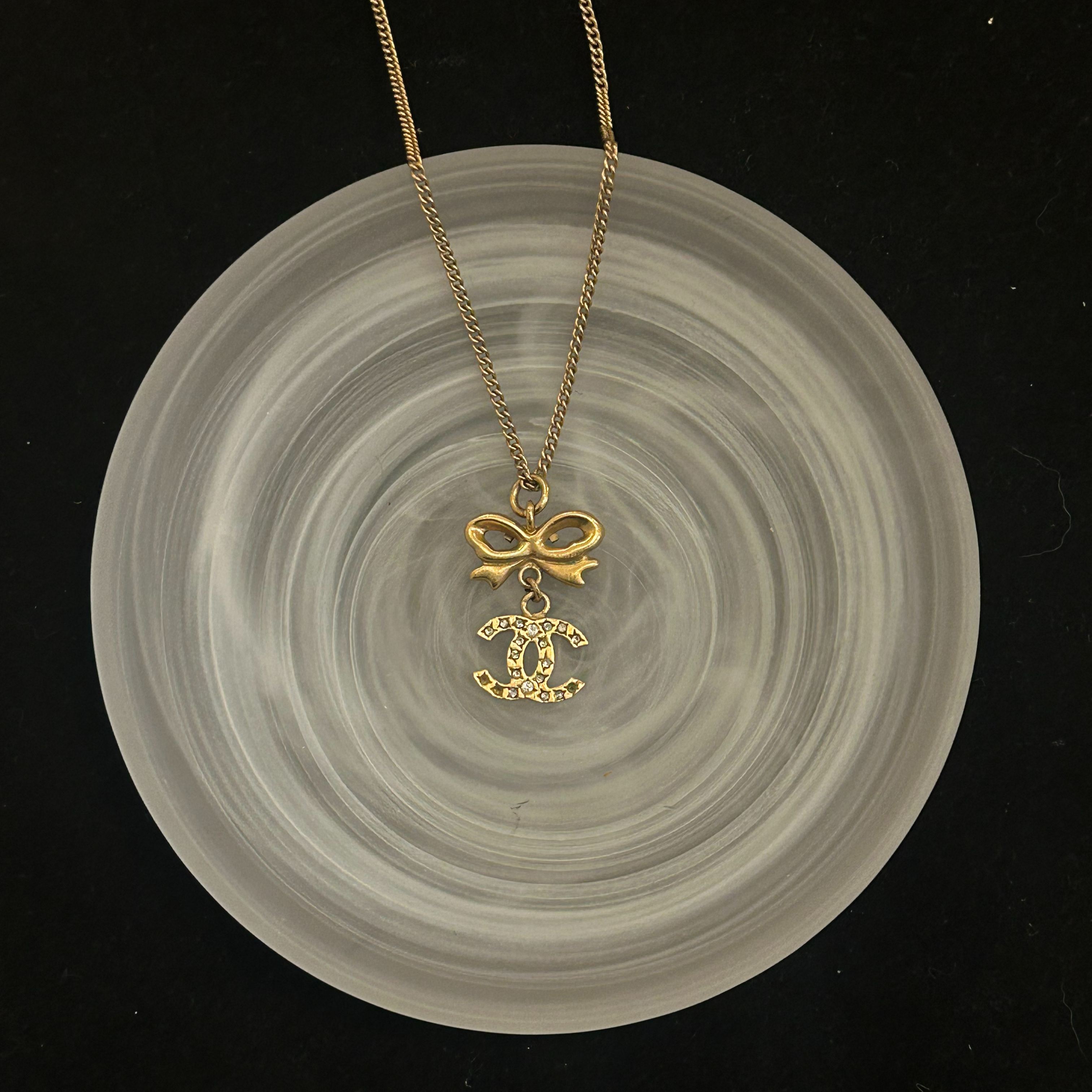 C Gold bow logo pendant necklace