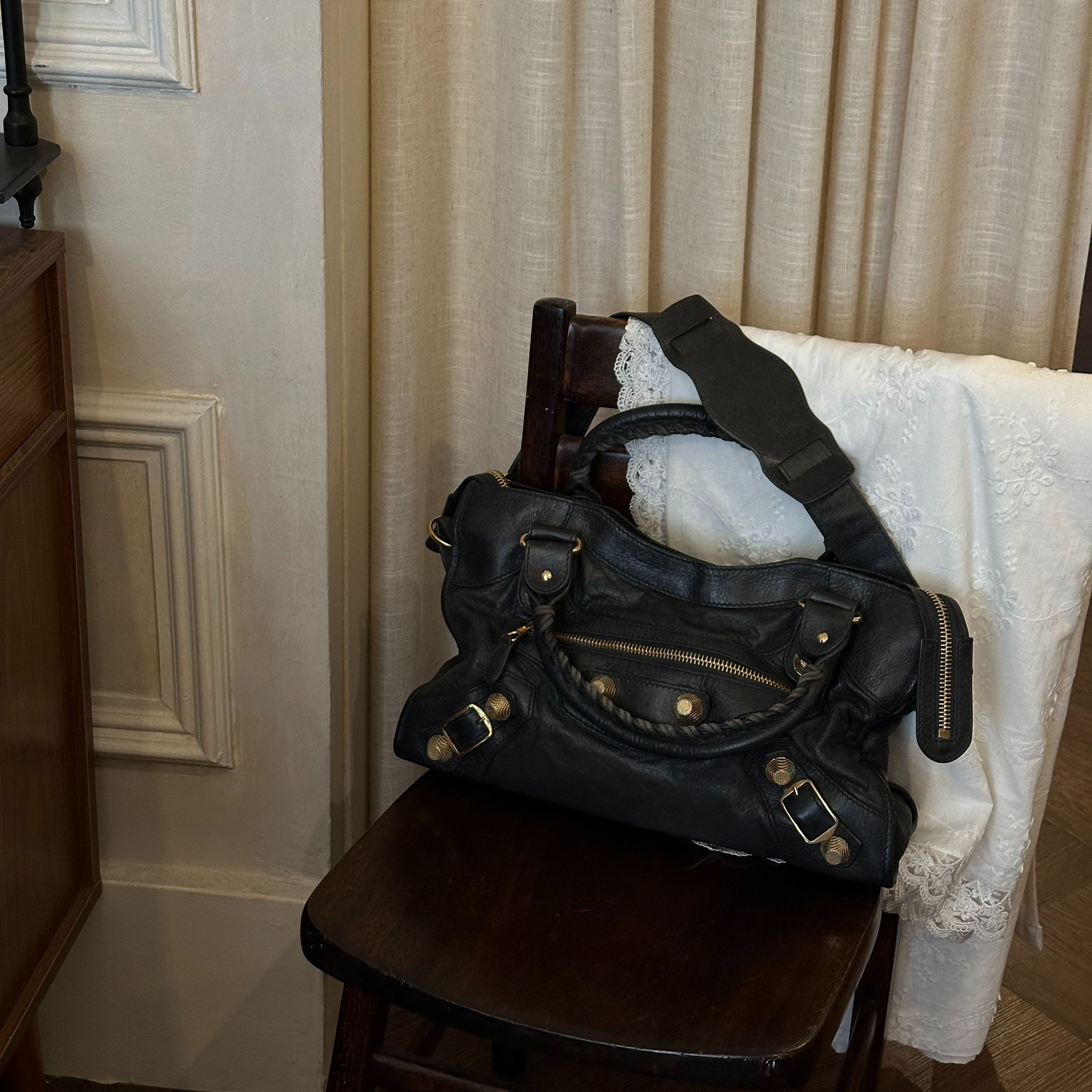 B Black and gold studded motorcycle bag