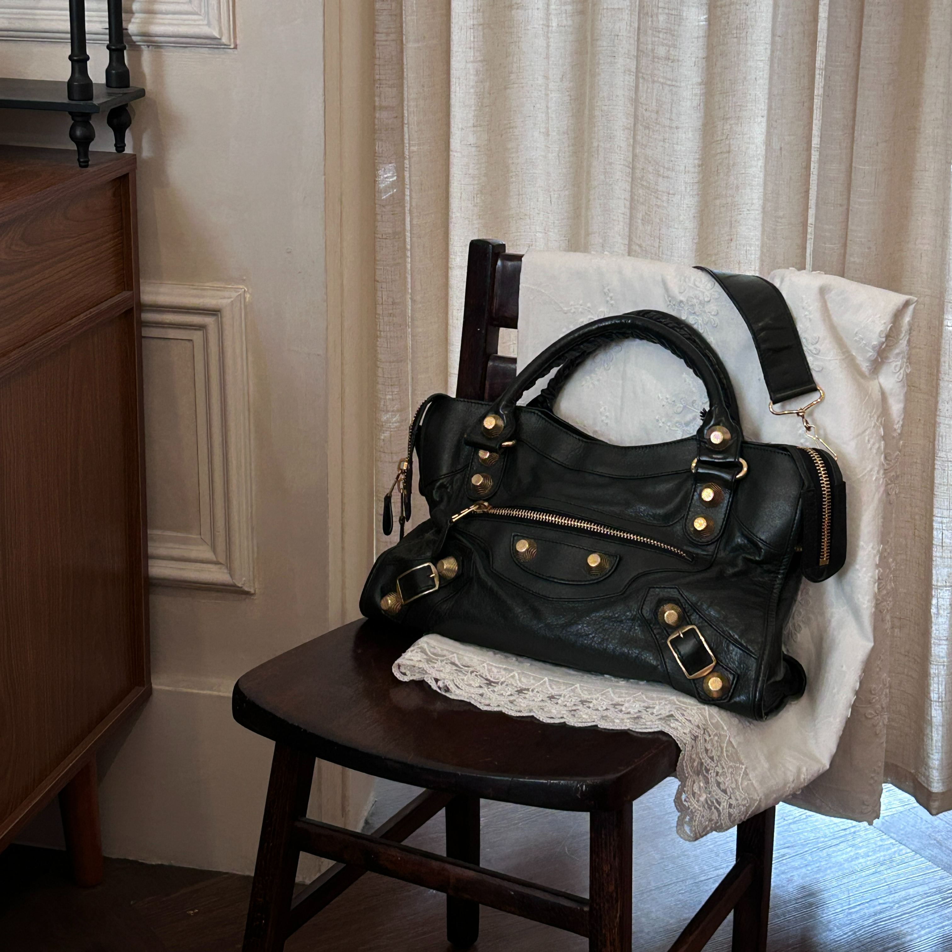 B Black and gold studded motorcycle bag