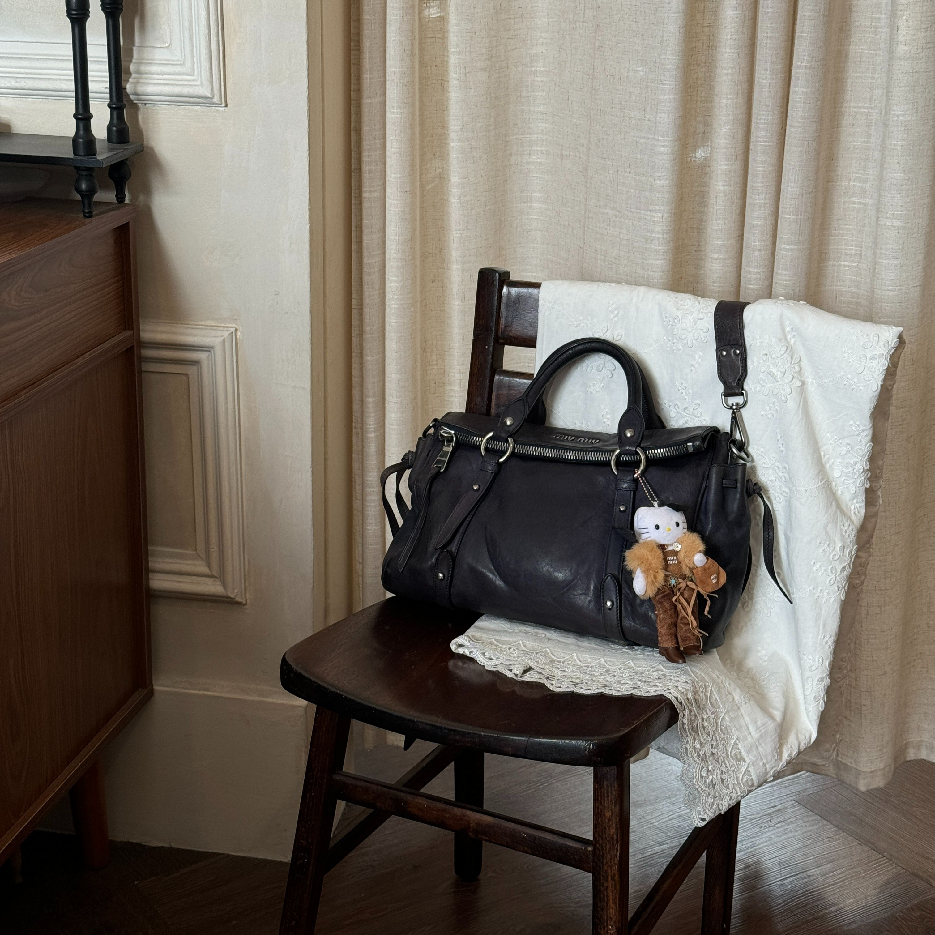 M Black and silver motorcycle bag