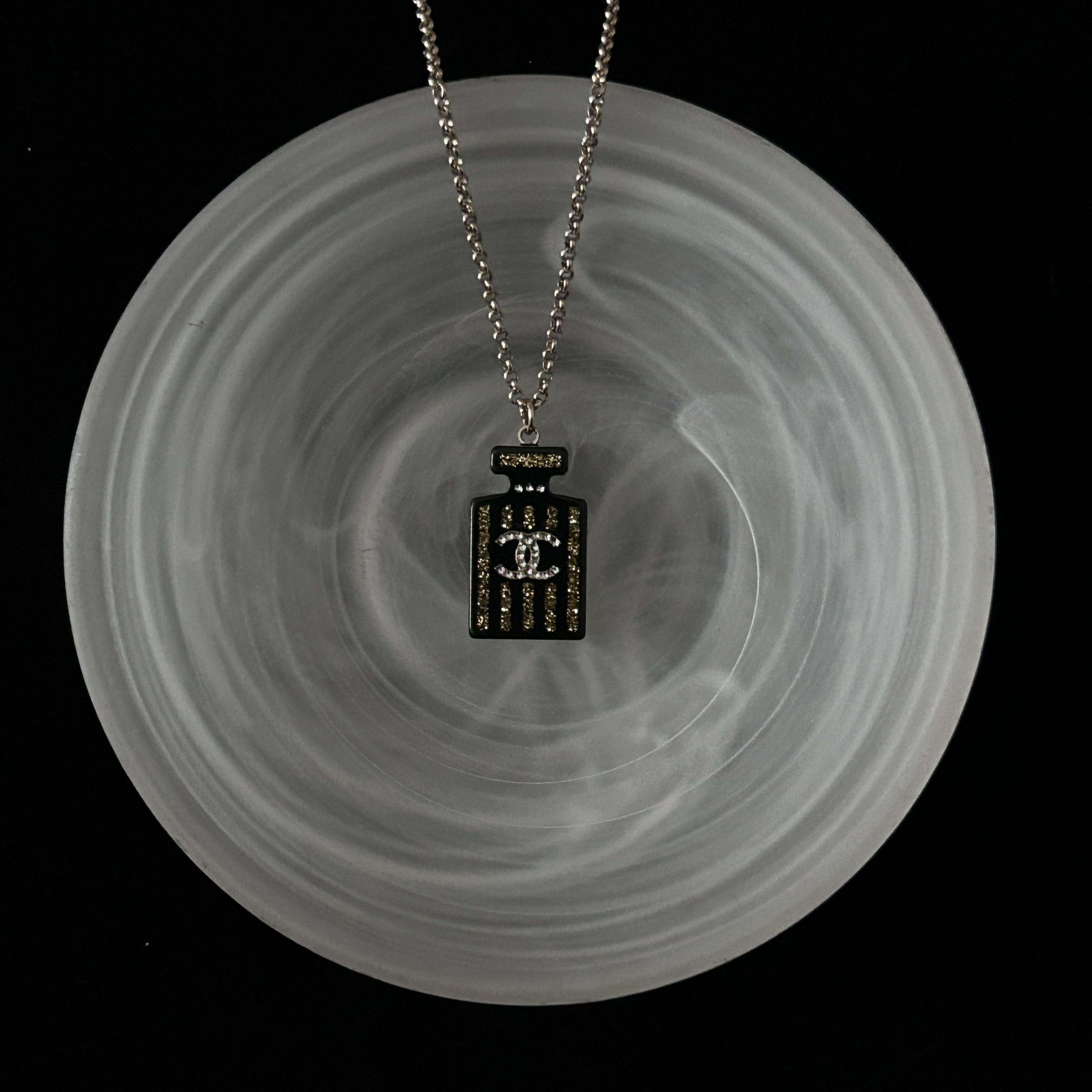 C Perfume bottle black and gold necklace