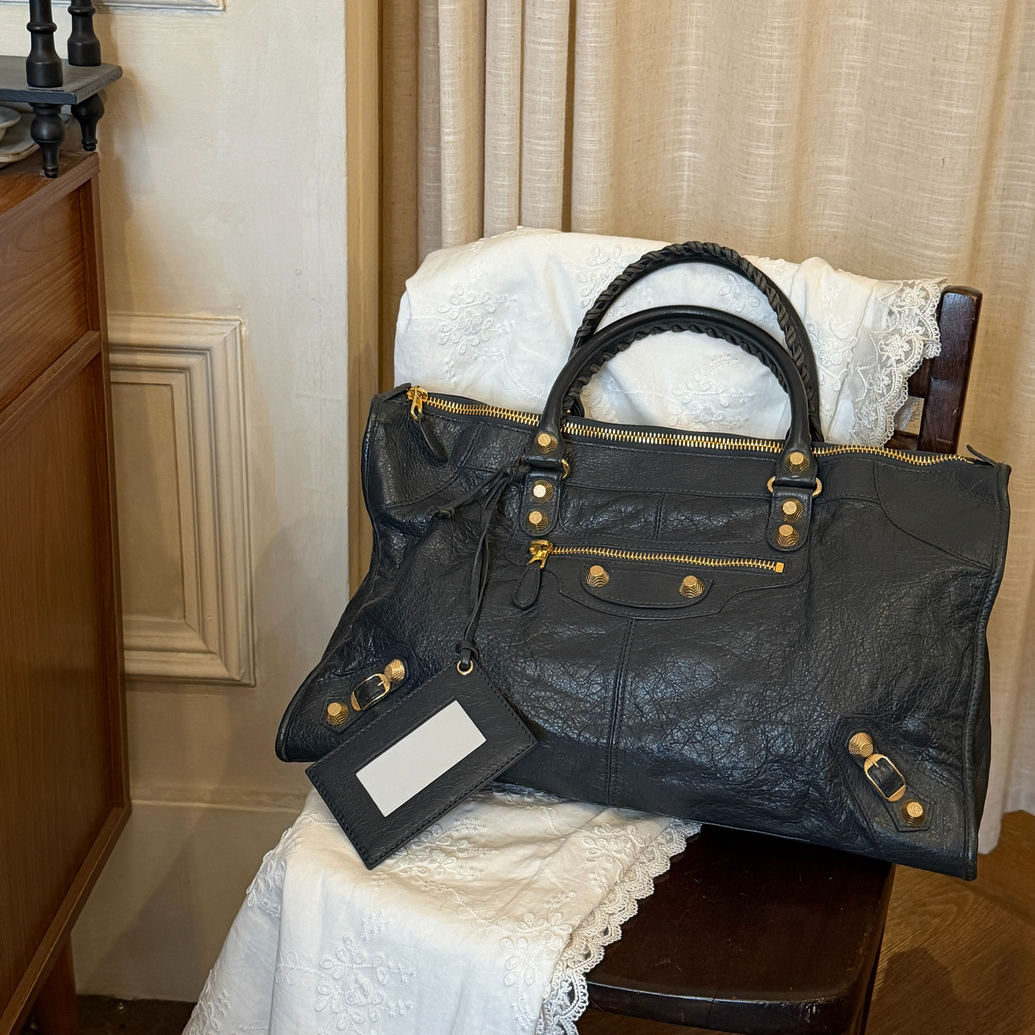 B Black and gold studded motorcycle bag