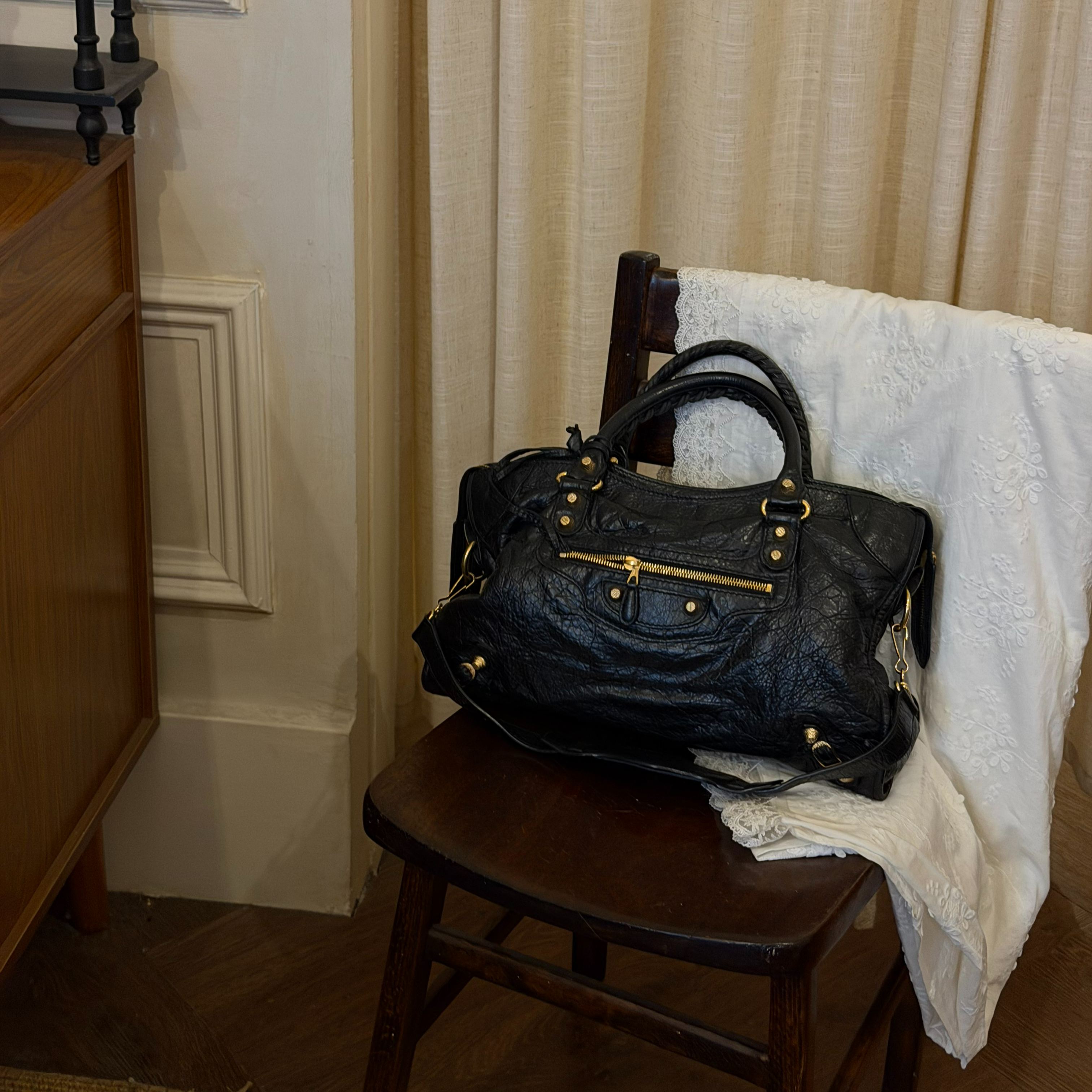 B Black and gold studded motorcycle bag