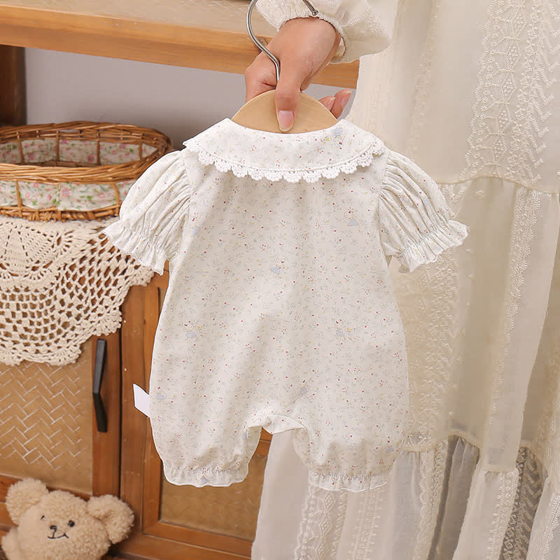 Tutina azzurra con fiocco e stampa floreale - image 2