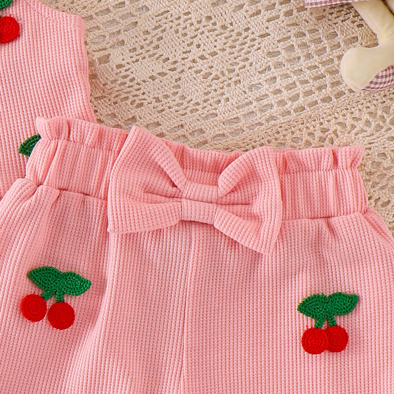 Completo da bambina composto da maglietta a maniche corte con spalline a nido d'ape e pantaloncini rosa con stampa floreale/ciliegia. - image 9