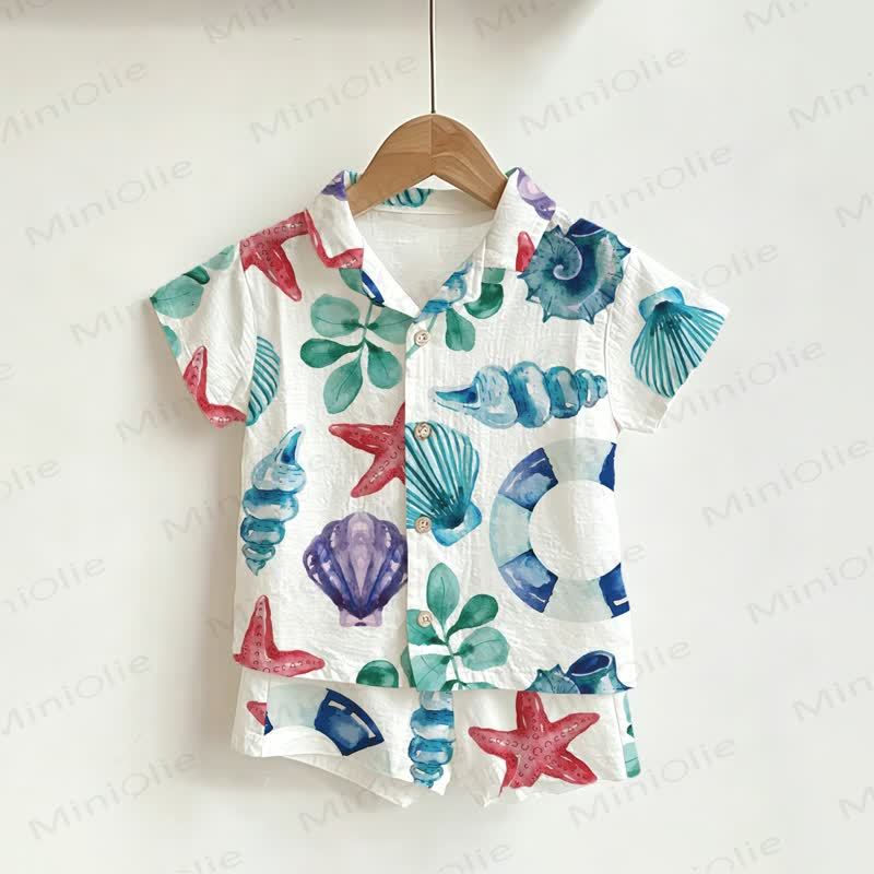 Completo da bambino composto da maglietta e pantaloncini bianchi con conchiglie e stelle marine. - Bianco - 3-5T - image 1