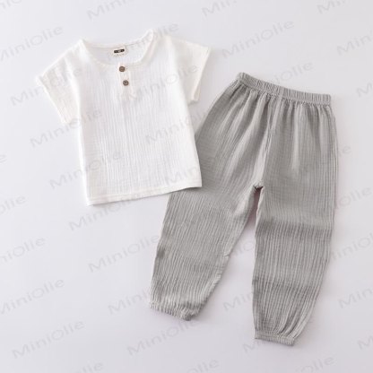 Completo per bambino composto da top e pantaloni in tinta unita con bottoni sul davanti, colore cotone. - Bianco e grigio - 6-7T - image 7