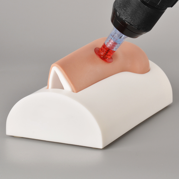 Demonstration of IO needle insertion on the adult tibial trainer