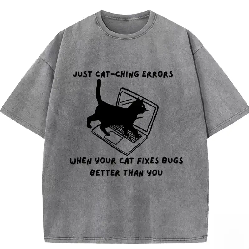 Humorous washed T-shirt featuring "When Your Cat Fixes Bugs Better Than You" design, perfect for cat lovers and tech enthu...