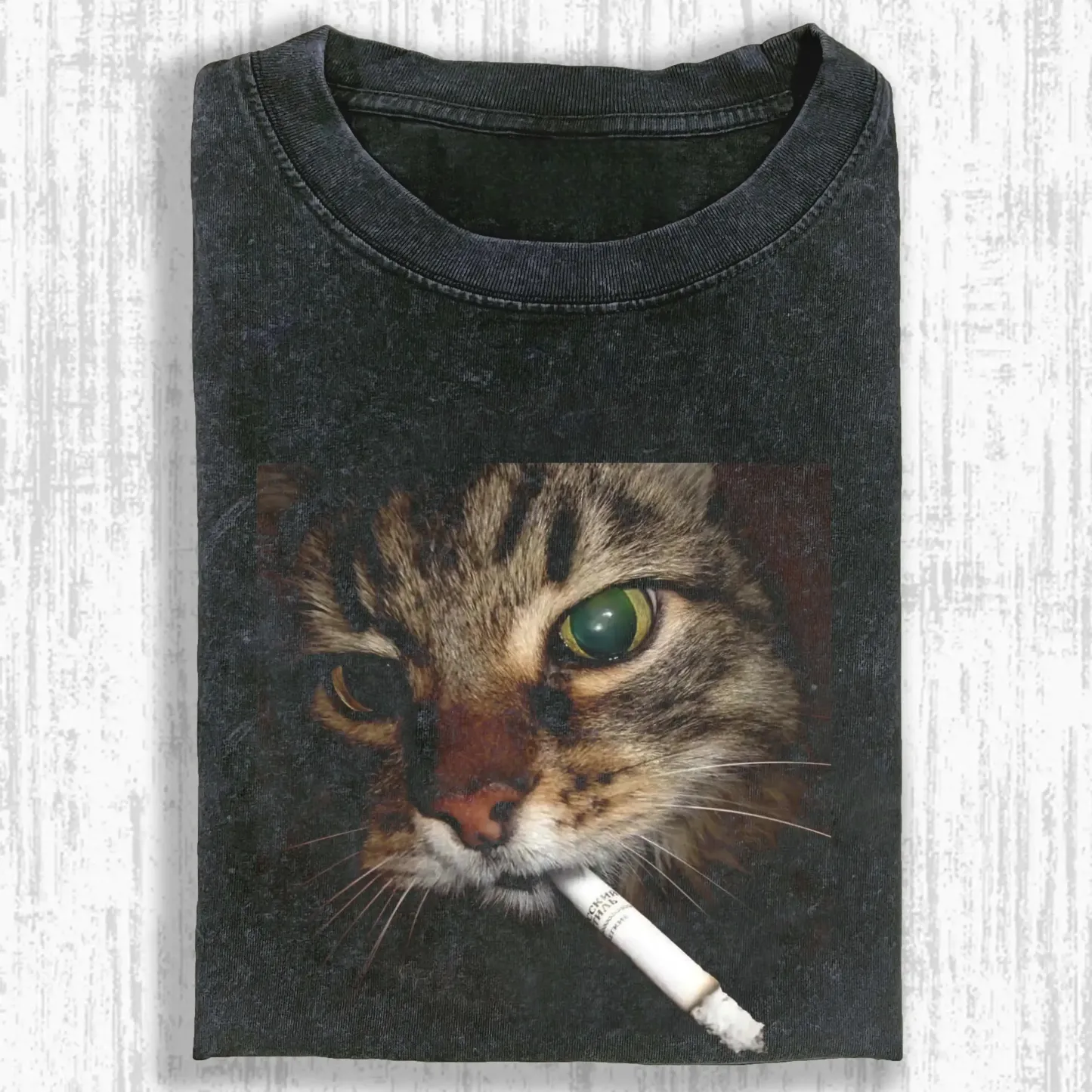 Washed T-shirt featuring a quirky smoking cat graphic, soft cotton fabric, perfect for casual wear and unique style.