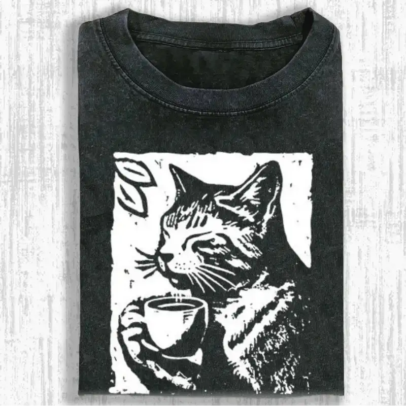 Coffee-drinking cat graphic on a soft, washed T-shirt for cat lovers, perfect for casual wear or gifting.