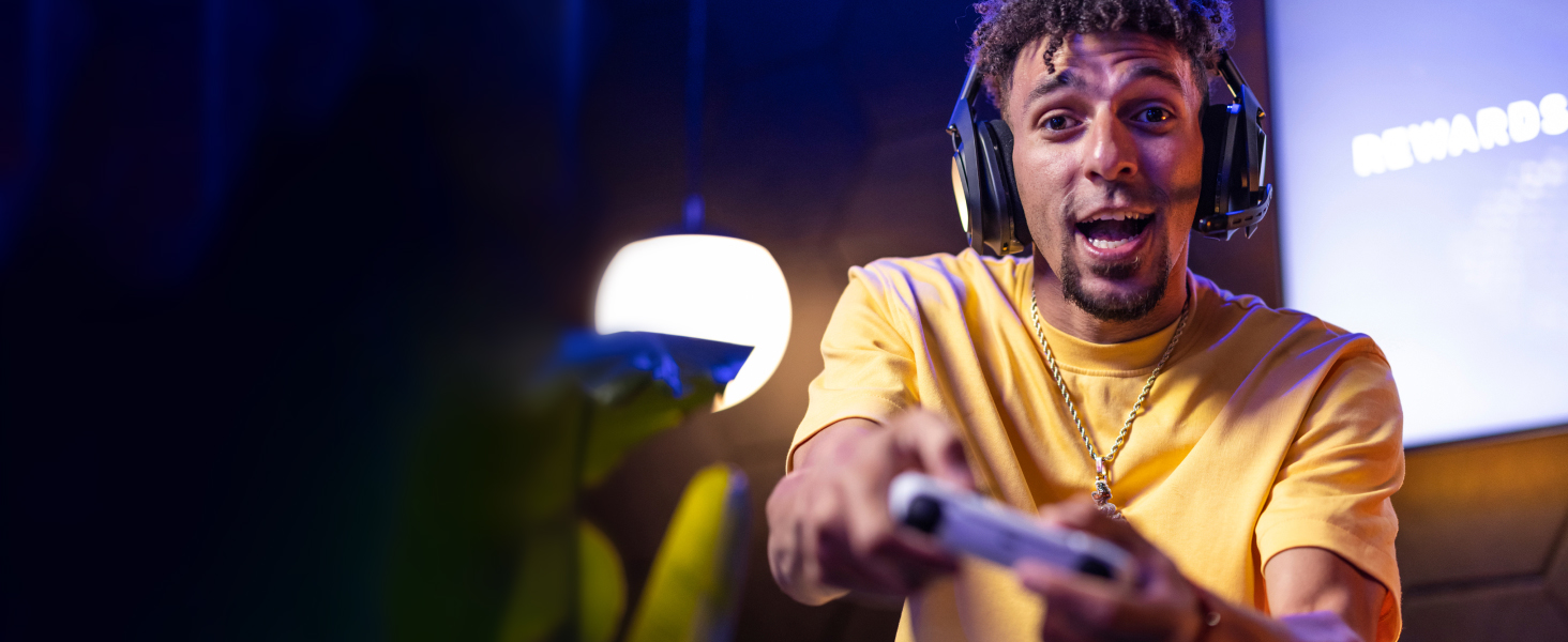 a man playing video games using a50 x lightspeed wireless gaming headset