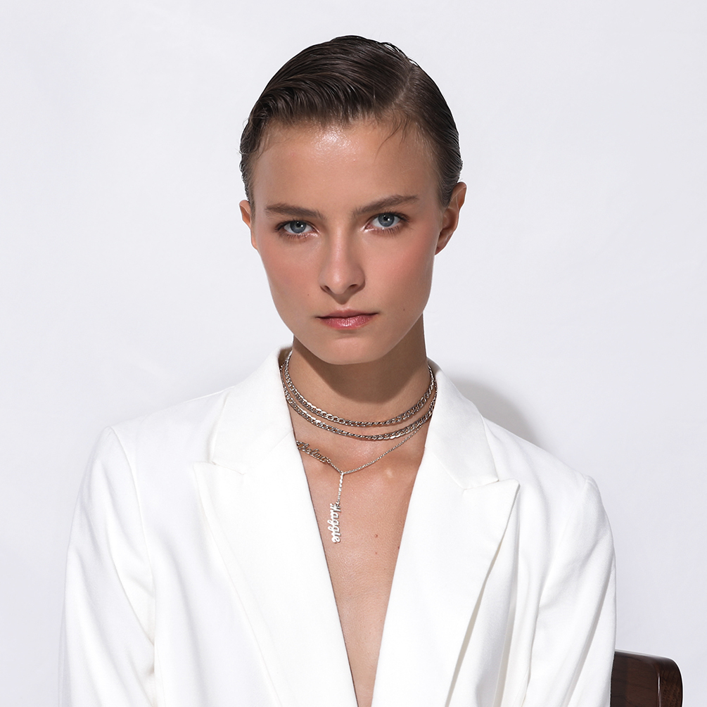 cuban chain necklace layered on female model