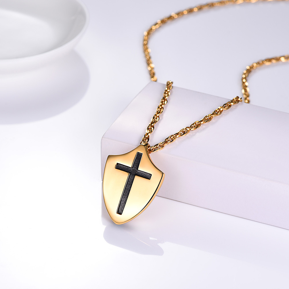 Gold Shield Necklace with Cross Pendant on White Stand | Christian Bible Verse Jewelry