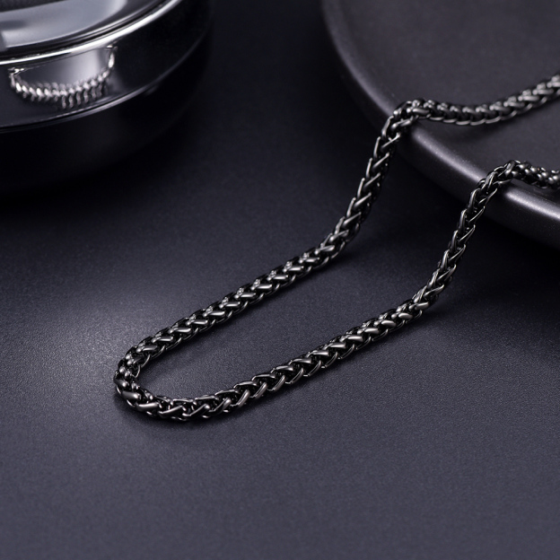 Black stainless steel wheat chain on dark background