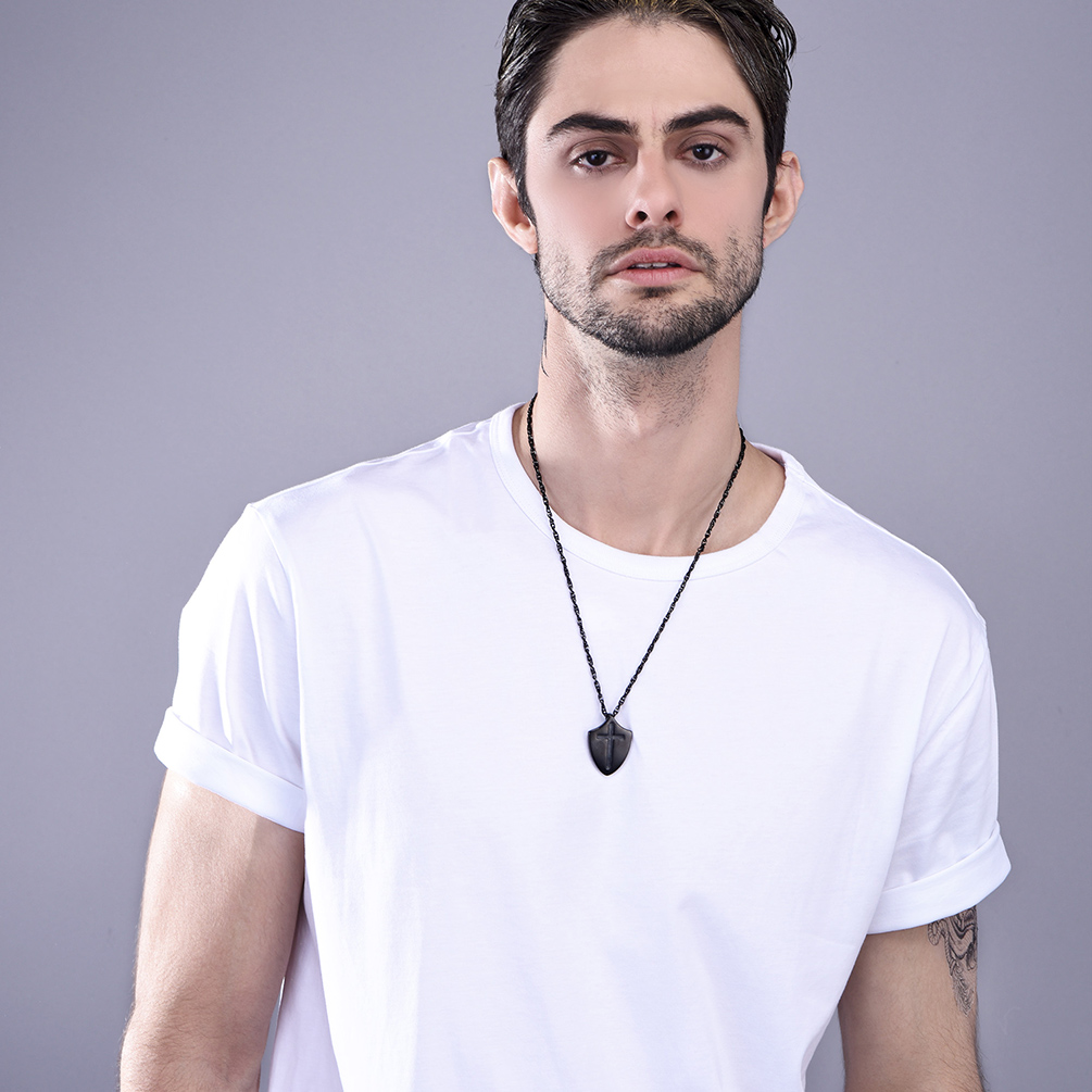 Black Shield Cross Necklace on Man in White T-Shirt