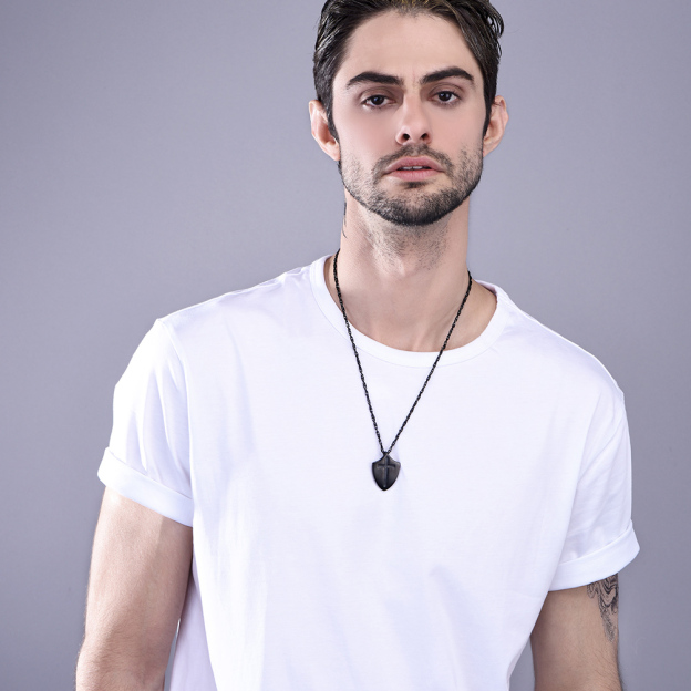 Black Shield Cross Necklace on Man in White T-Shirt