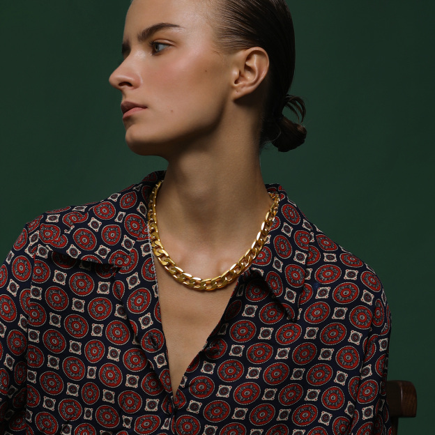 Gold Cuban link necklace on female model