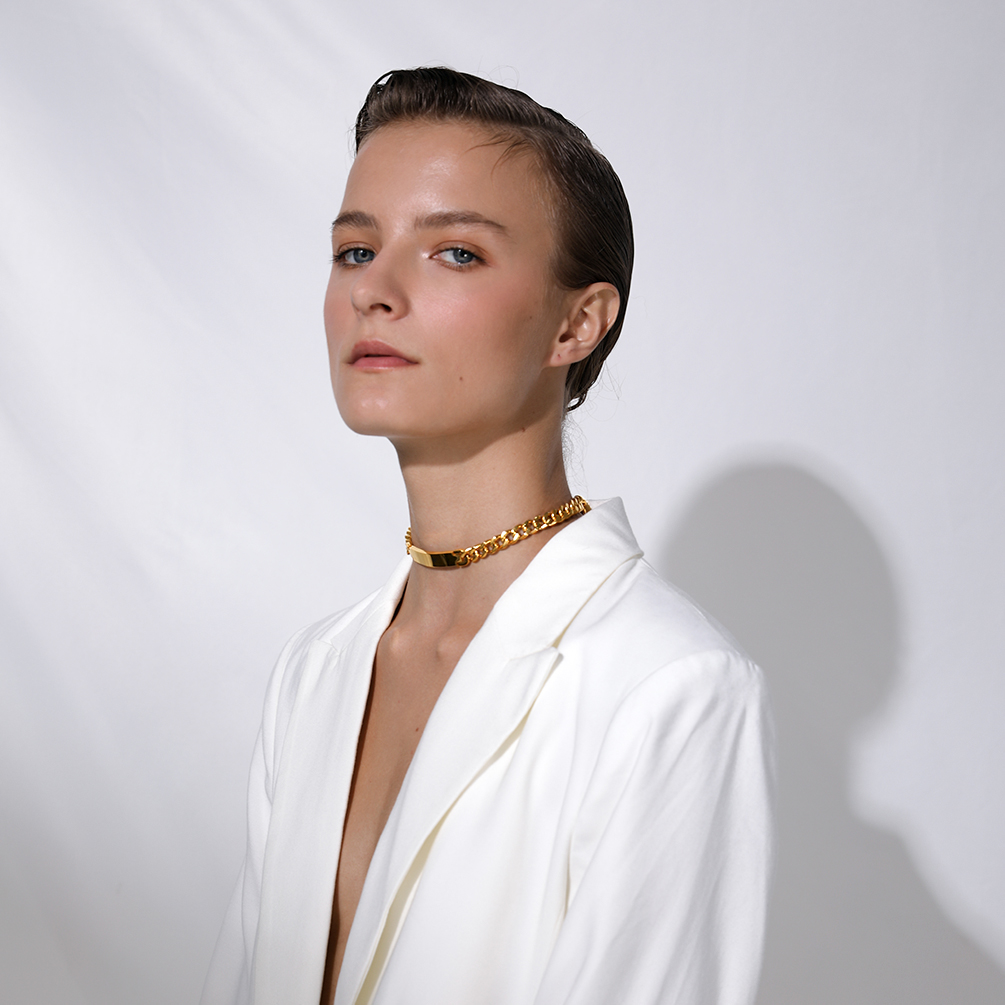 Model wearing gold stainless steel choker necklace