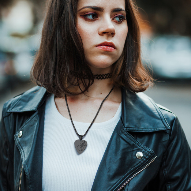 Woman in leather jacket with black guitar pick necklace