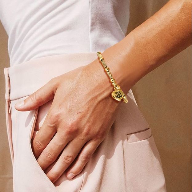 Gold Allah heart beads bracelet on woman wrist