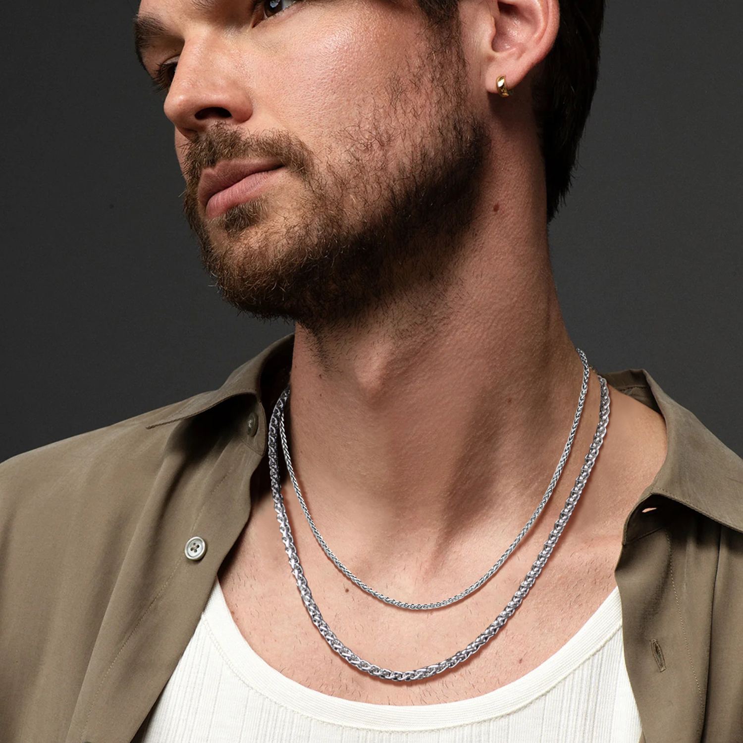 Men wearing wheat chain layered necklace