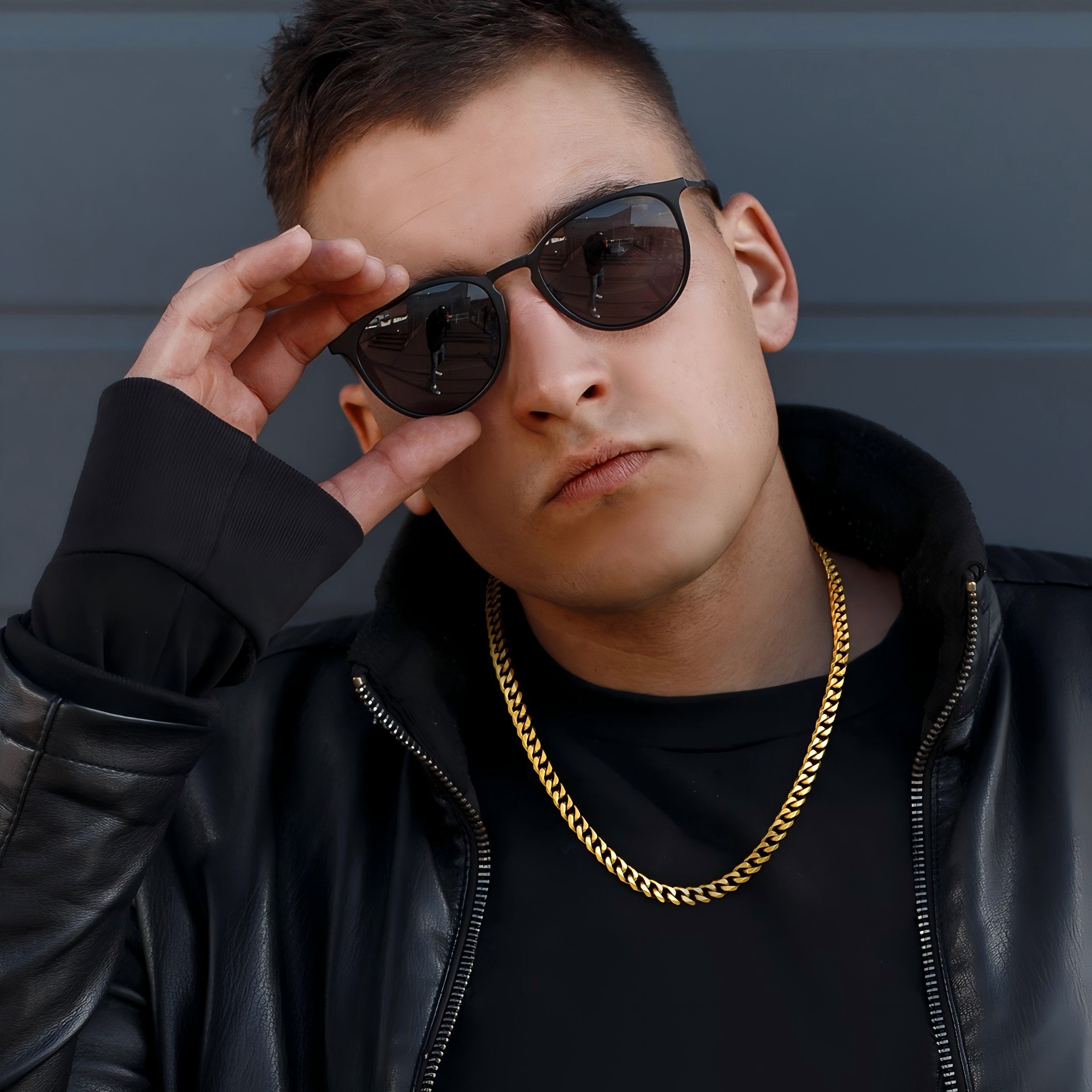 Gold Cuban Link Chain on Man in Black Leather Jacket