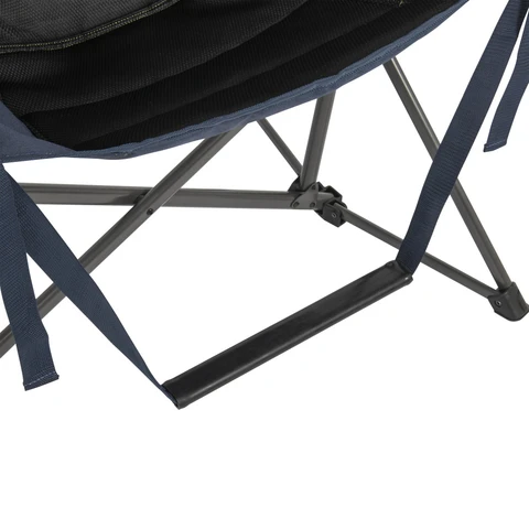Footrest bar hanging from frame of chair.