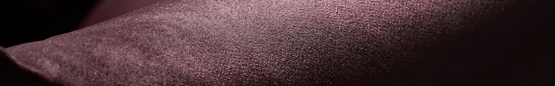 Close-up texture of deep mauve shimmer fabric and luxury velvet upholstery for the clearance sale banner.