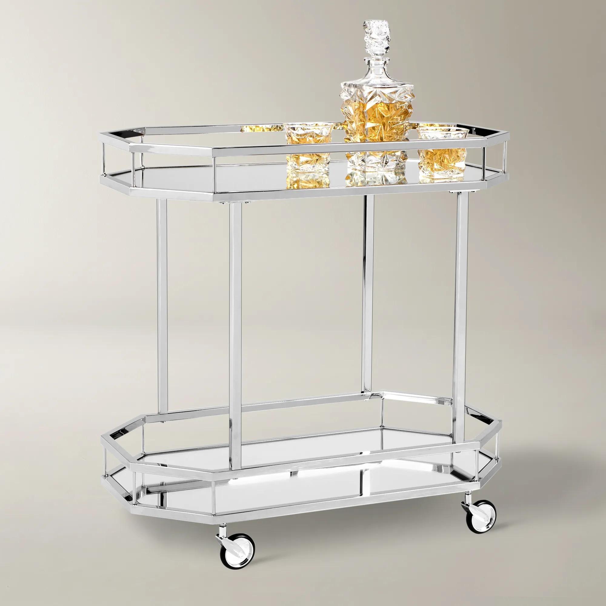 two-tier chrome bar cart with glass decanter and glasses on top shelf