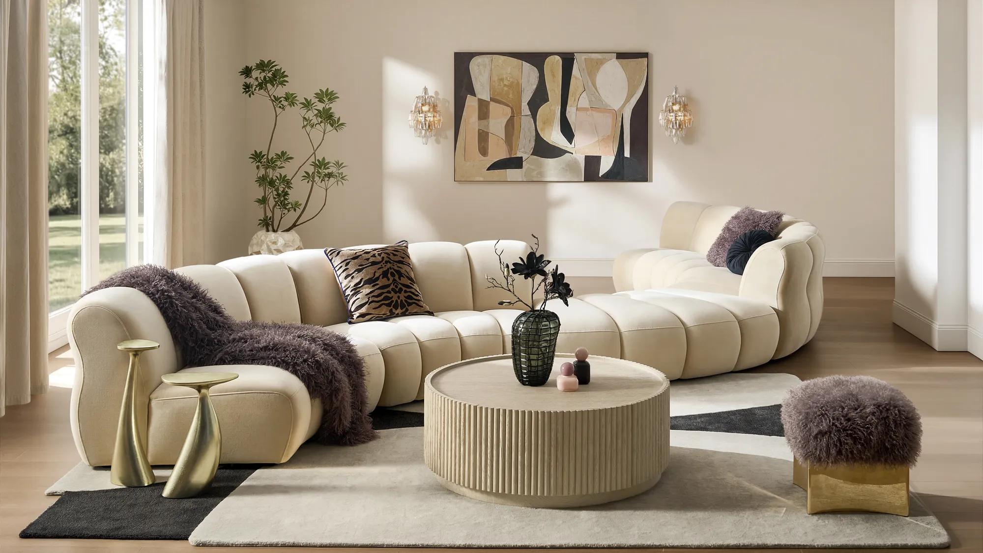 sculptural velvet accent stool beside a curved sofa