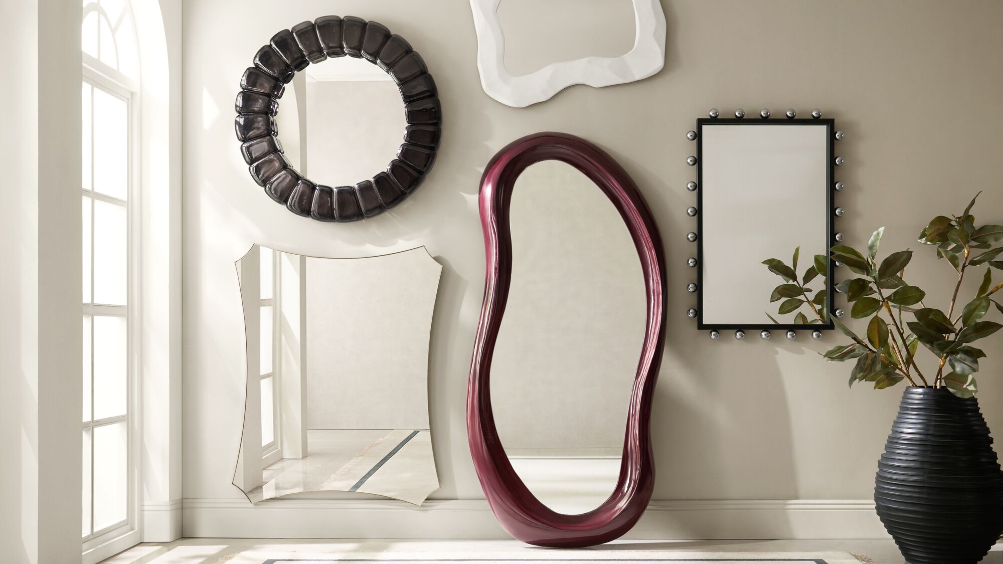 Layered forms and varied finishes create a wall moment that feels collected and artfully composed.