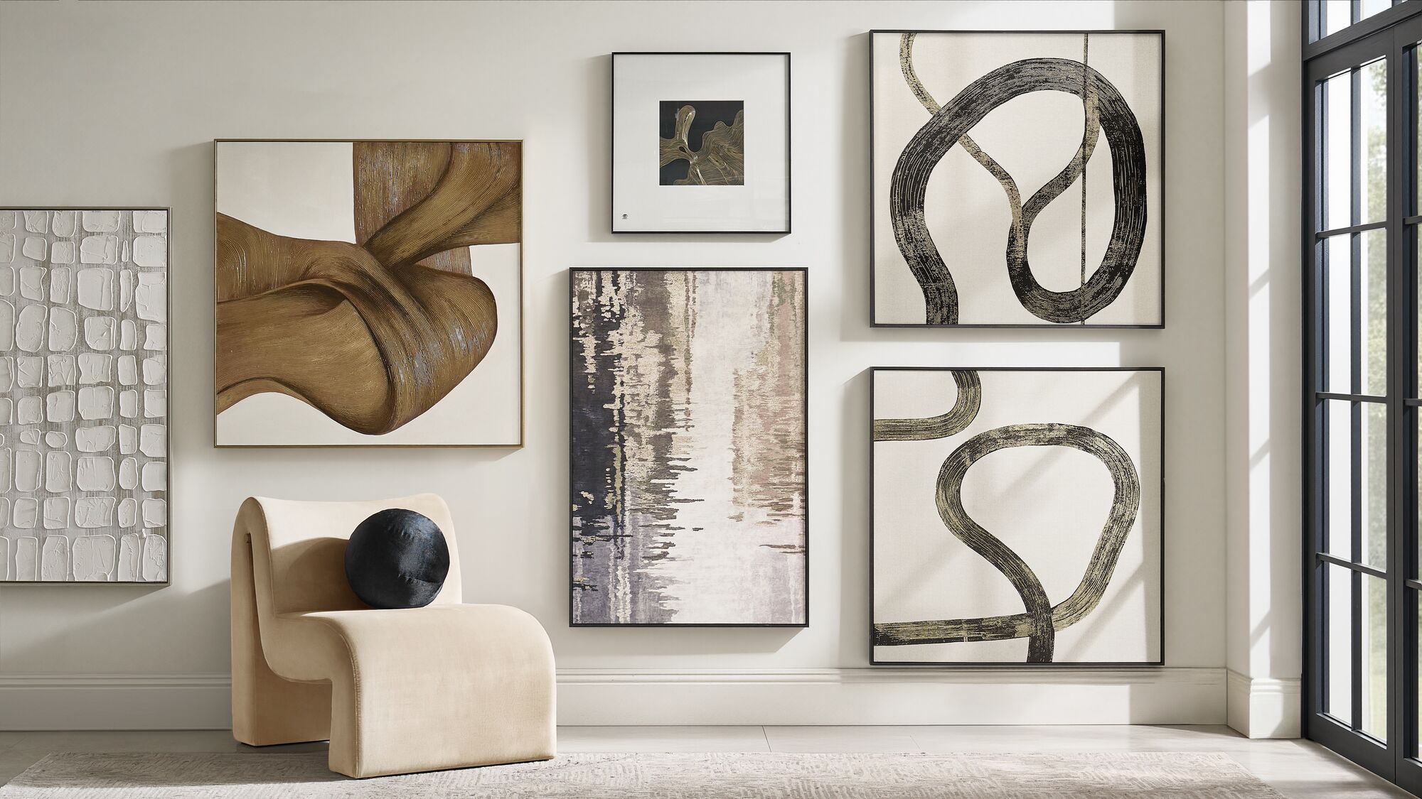 Layered abstraction, sculptural seating, and tonal contrast create a corner with quiet authority.