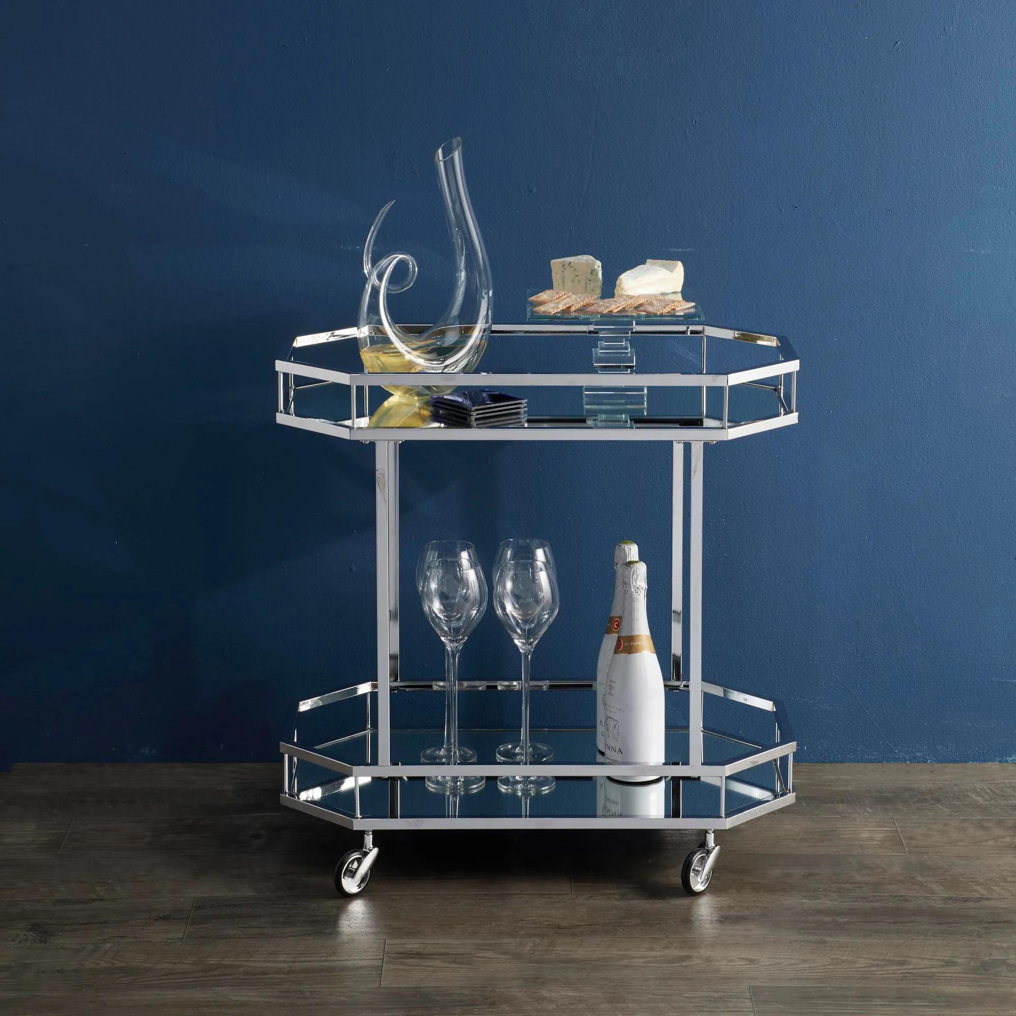 bar cart with glassware and cheese on a blue wall