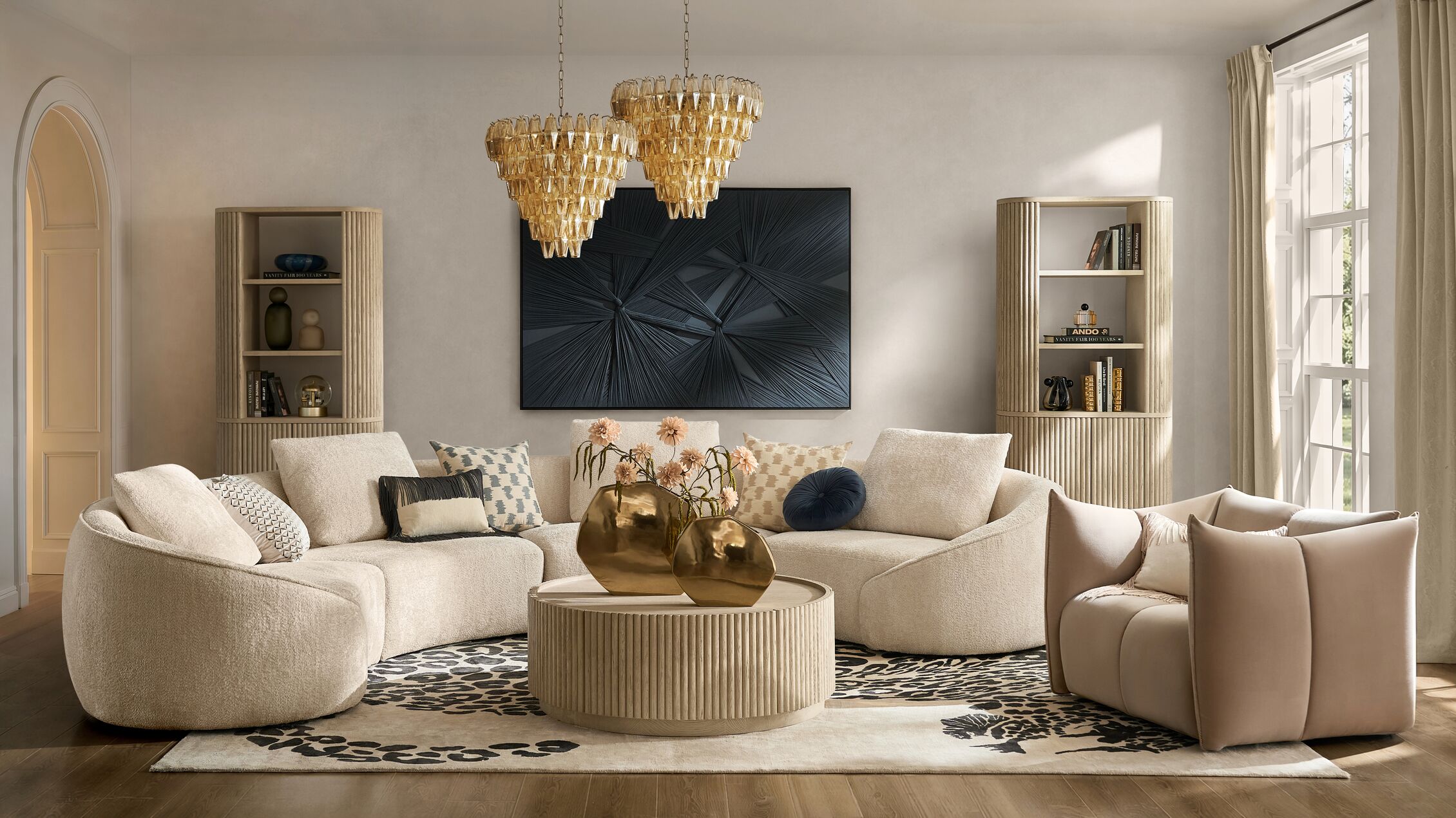 Embrace the art of curved sophistication with textural bouclé seating, sculptural ribbed accents, and the warm glow of artisanal brass.