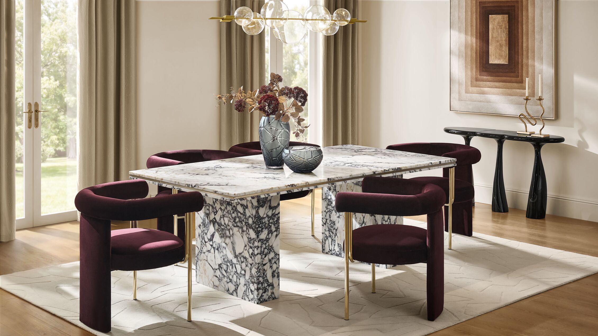 Make every dining experience an occasion with striking marble veins, rich plum velvet, and glass accents that anchor the room in absolute sophistication.