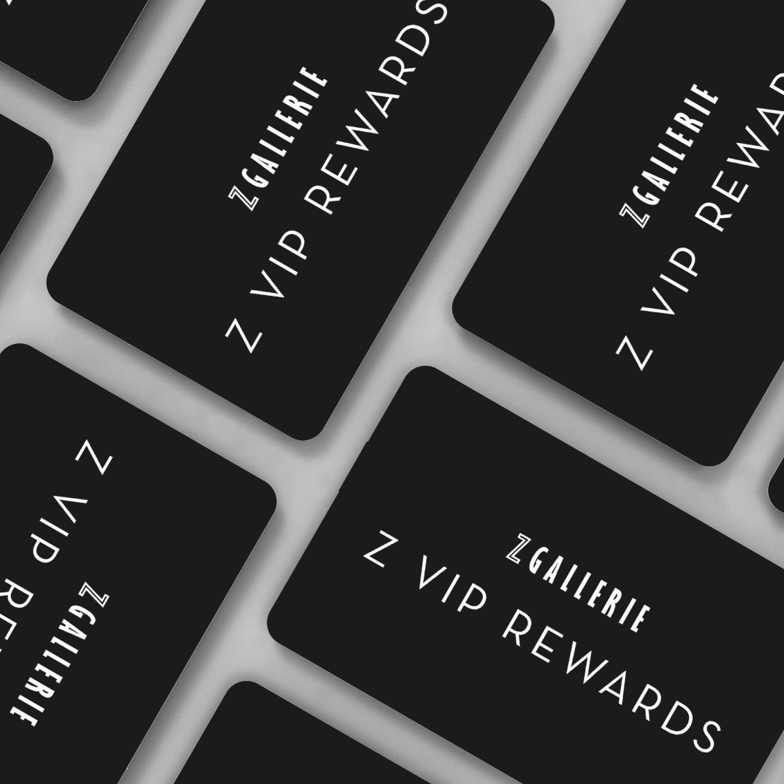 Black Z Gallerie VIP Rewards membership cards laid out in a repeated grid pattern. title: Join Z Gallerie VIP Rewards to earn exclusive perks and discounts