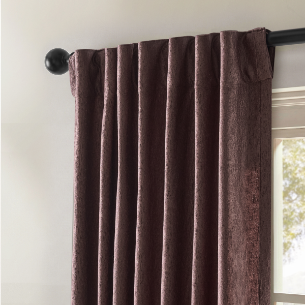 Rich dark plum velvet window curtain panel hanging from a black decorative drapery rod. title: Explore velvet curtains, window drapes, and window treatment panels