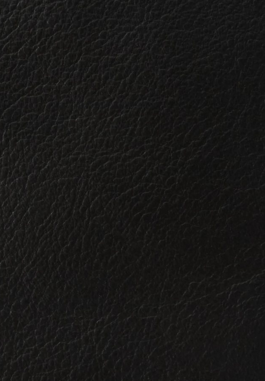 Detailed texture of premium black genuine leather upholstery with fine natural grain.