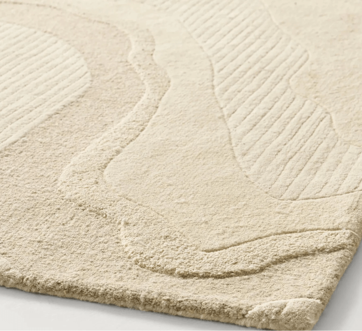 Detailed texture of a distressed abstract performance rug in silver, grey, and cream durable fibers.