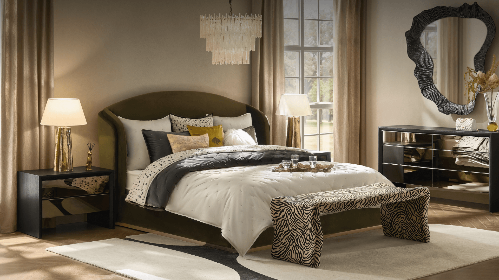 Elegant modern bedroom styled with an olive green arched bed, zebra print bench, mirrored dresser, and wavy wall mirror.