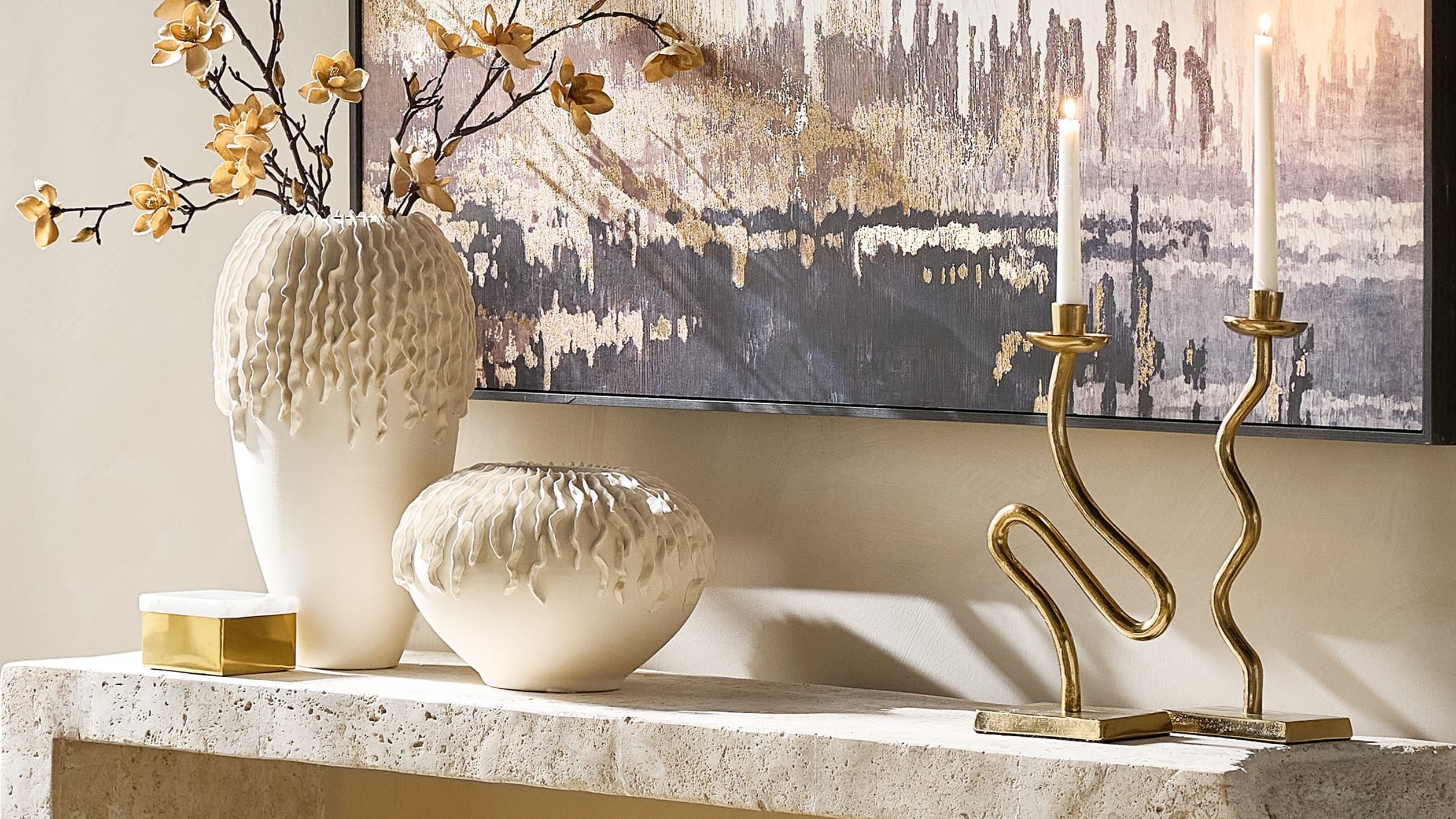 Ceramic volume, brushed brass, and painterly abstraction create a composition with depth, warmth, and a distinctly collected finish.