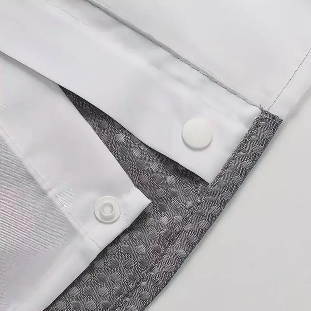 Close-up of the press-stud attachment on a waffle shower curtain