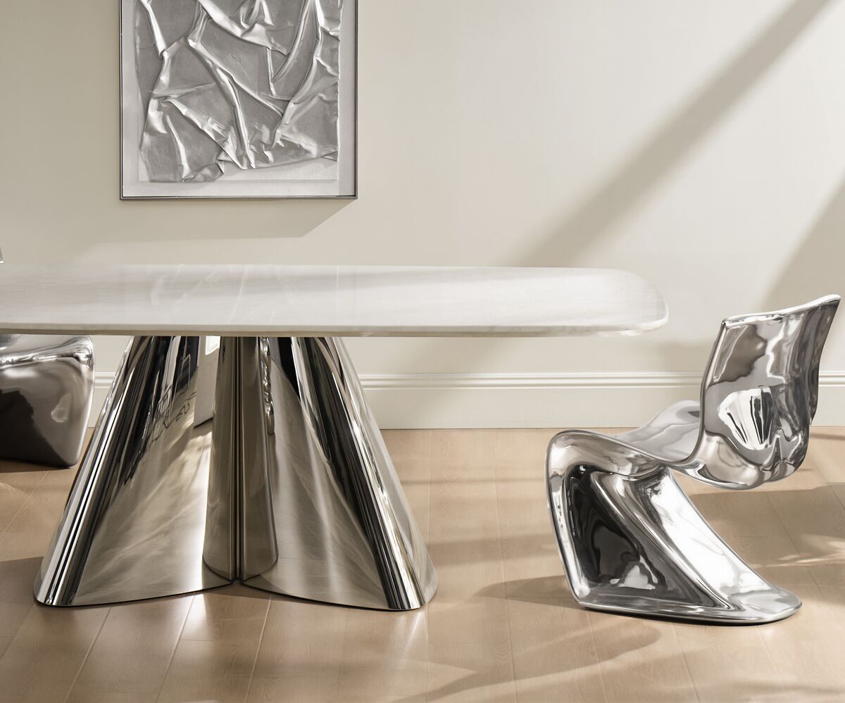 Matera marble dining table featuring a sleek white top and polished stainless steel sculptural legs.